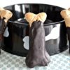 carob dipped dog milk bones leaning upright against dogbowl