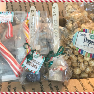 Kit wih bags of caramel popcorn, hot chocolate stirrers, candy canes, and reindeer food