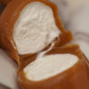 close up Caramellow split in half to reveal marshmallow center