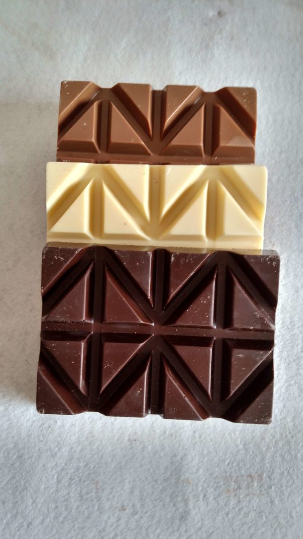 Stack of dark, white, and milk bars of chocolate