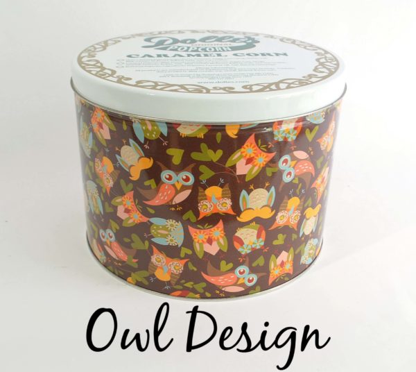 tin of Dolle's® Popcorn decorated with owls and heart shaped leaves artwork