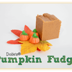 piece of Pumpkin Fudge on fall leaves with Mellowcreme Pumpkins