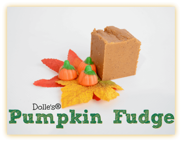 piece of Pumpkin Fudge on fall leaves with Mellowcreme Pumpkins