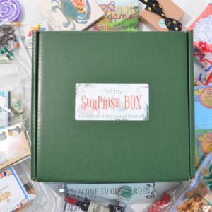 Holiday Surprise Box surrounded by variety of goodies